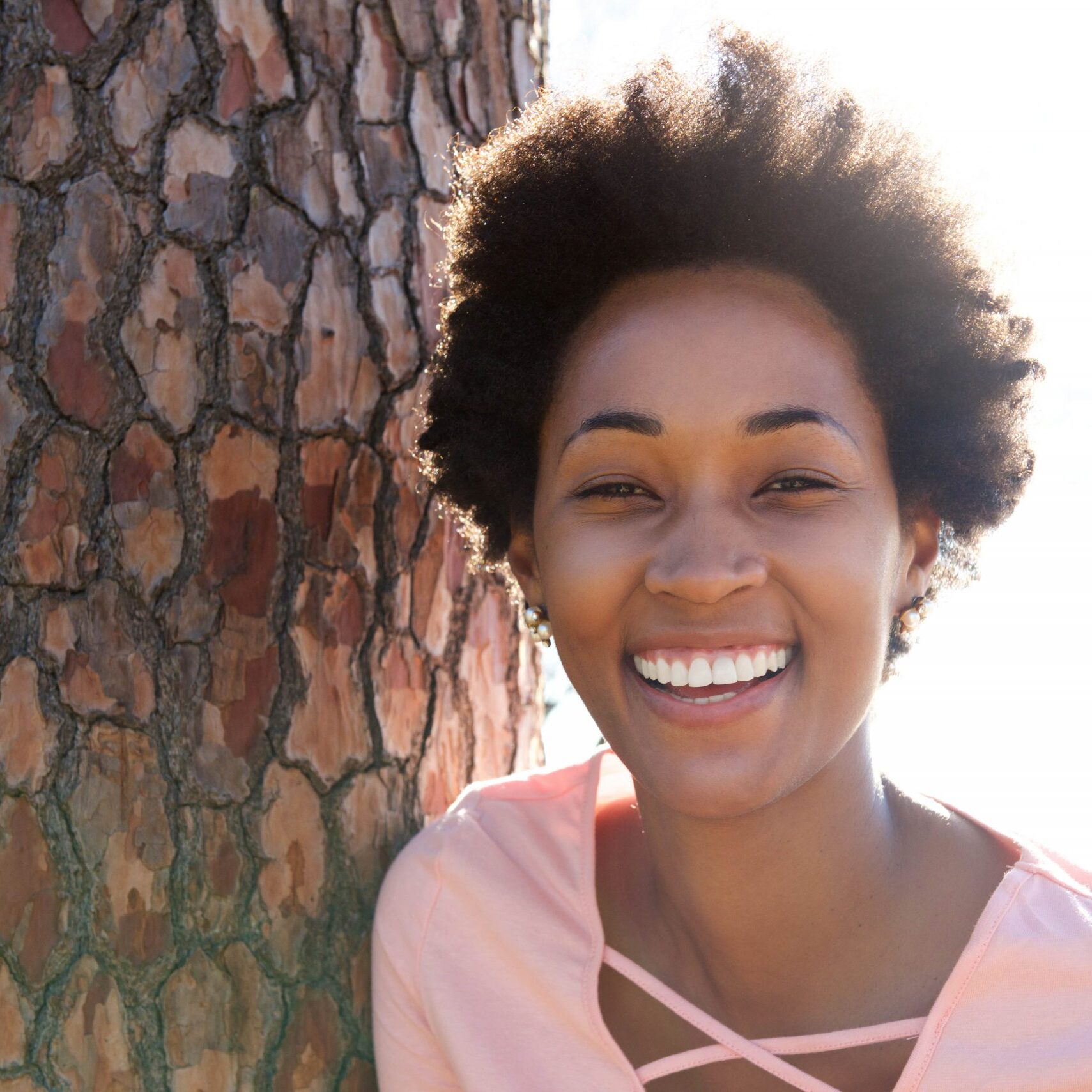 beautiful-young-african-woman-leaning-on-tree-PV5NZD3-min beautiful-young-african-woman-leaning-on-tree-PV5NZD3-min